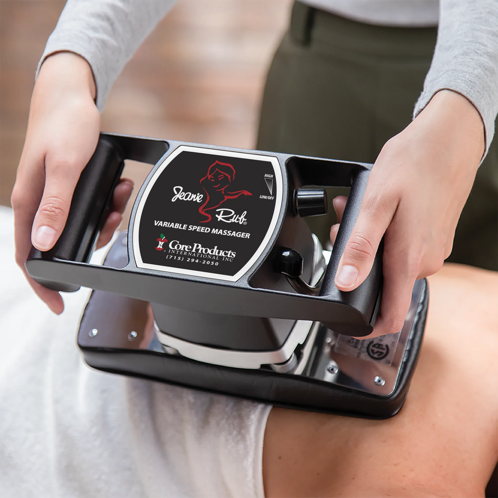 Person using a handheld massager labeled 'Jeanne Rub' on a person's back. 