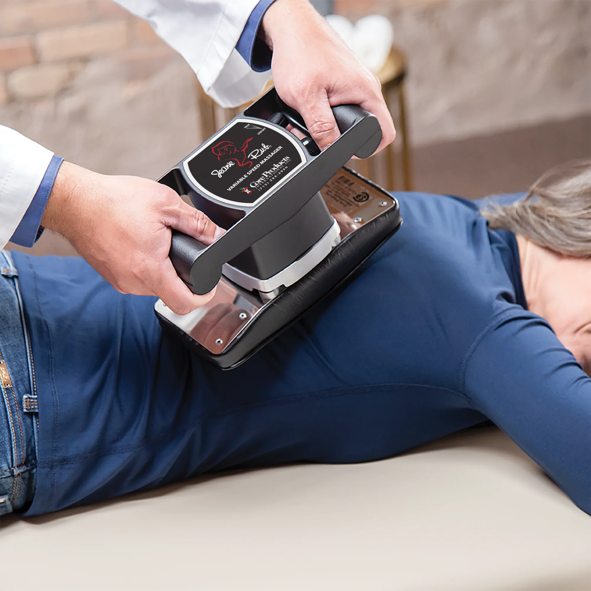 Person using a handheld device on another person lying on a couch.